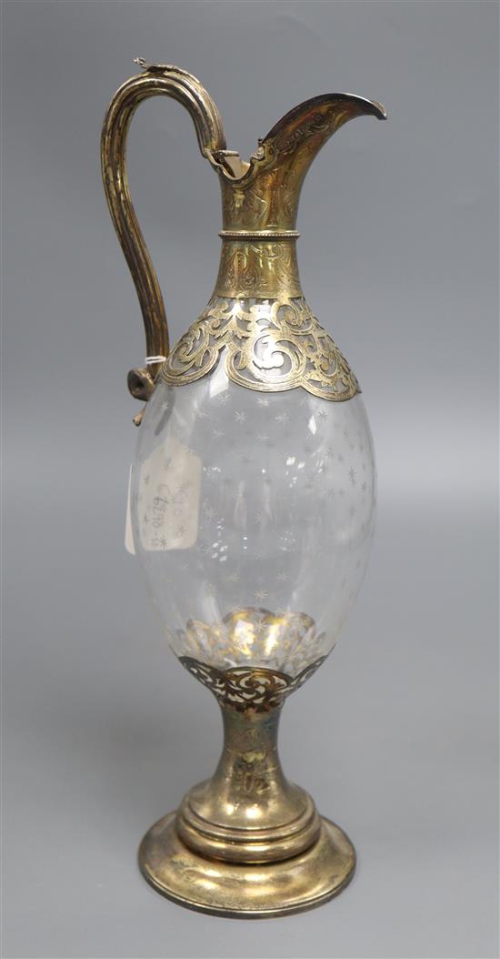 A Victorian silver gilt and engraved glass claret jug, makers mark CF, Sheffield 1876, 35.5.cm